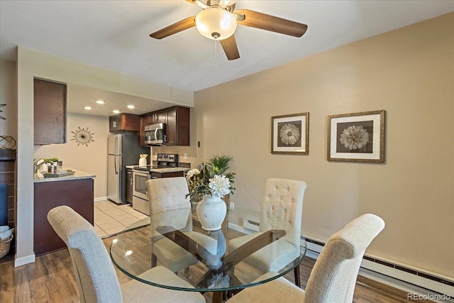 dining room featuring a baseboard heating unit, baseboards, baseboard heating, and ceiling fan