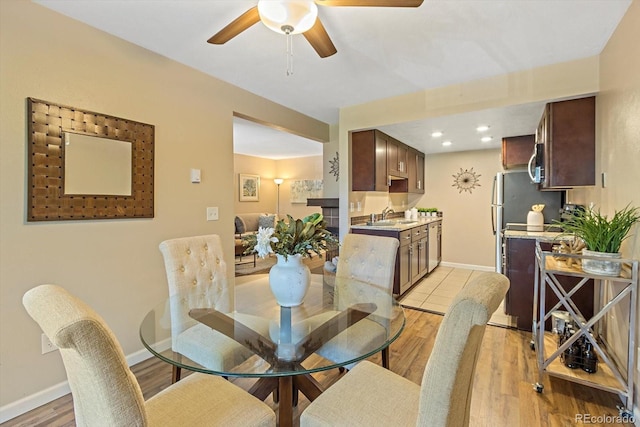 dining space featuring ceiling fan, baseboards, light wood-style flooring, and recessed lighting