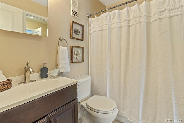 bathroom with visible vents, toilet, and vanity