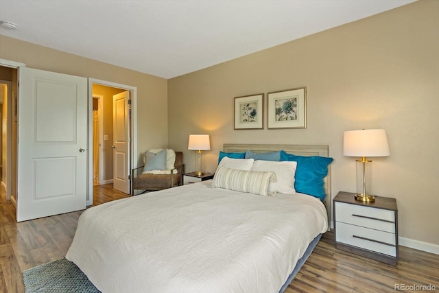 bedroom featuring baseboards and wood finished floors