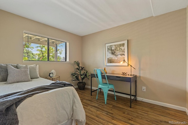 bedroom featuring baseboards and wood finished floors