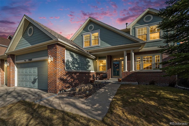 view of front facade featuring brick siding, concrete driveway, and a garage