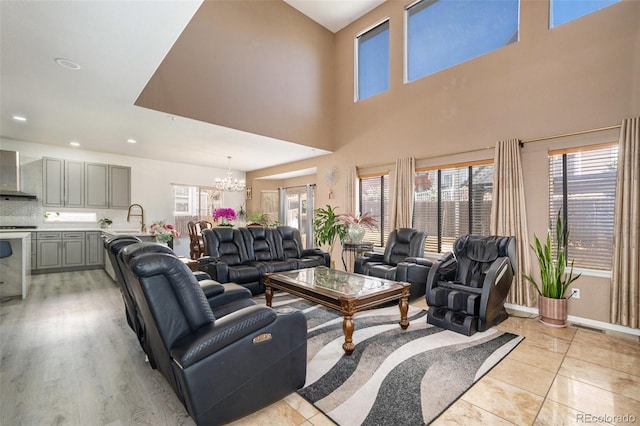 living room featuring light tile patterned floors, baseboards, visible vents, an inviting chandelier, and recessed lighting