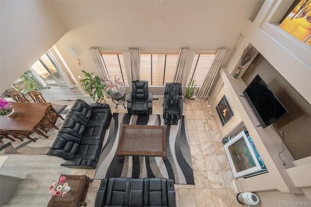 living room featuring a towering ceiling