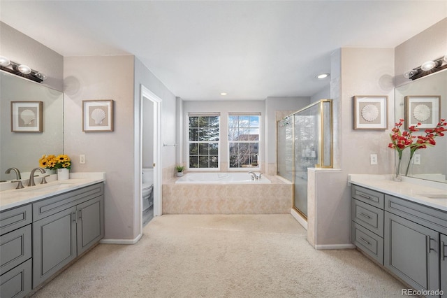 full bathroom with a shower stall, baseboards, toilet, a bath, and vanity