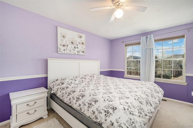 carpeted bedroom with baseboards and ceiling fan