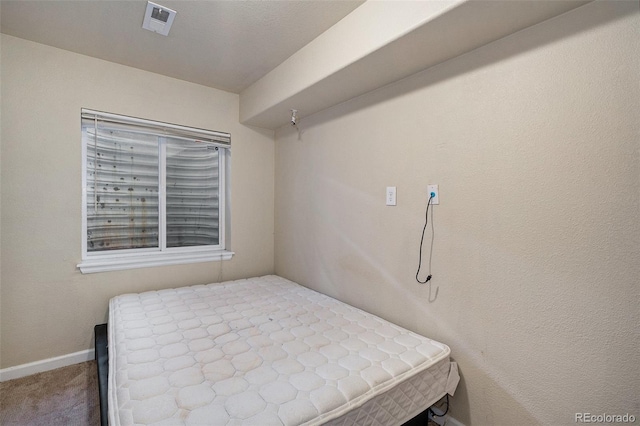 carpeted bedroom featuring baseboards and visible vents