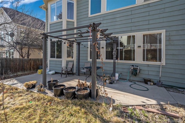 view of patio / terrace with a pergola and fence