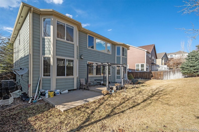 back of house with a pergola, a patio, fence, a yard, and a residential view