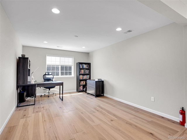 office area featuring light wood-style floors, recessed lighting, baseboards, and visible vents