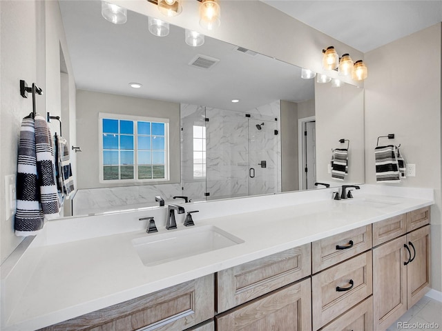 full bathroom featuring a sink, a marble finish shower, double vanity, and visible vents