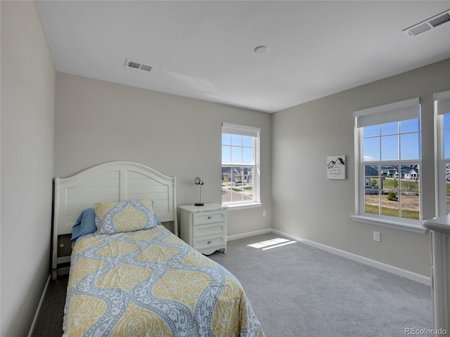 bedroom featuring visible vents, carpet, and baseboards
