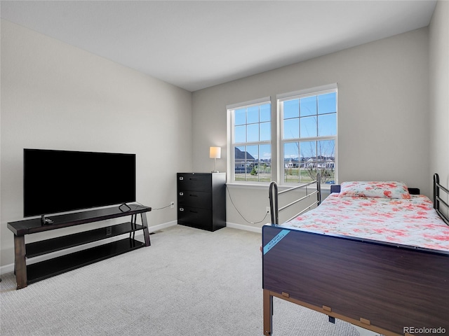 bedroom featuring baseboards and light carpet