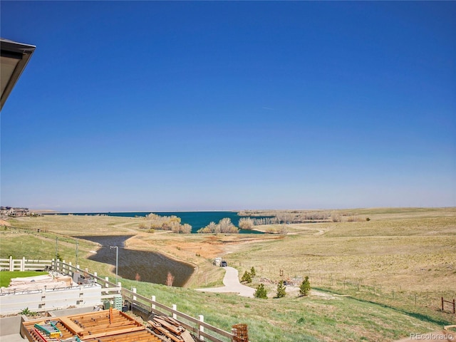 exterior space featuring a water view and fence