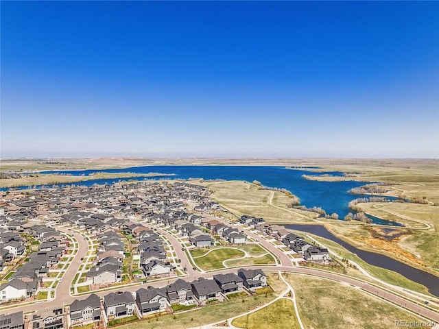 drone / aerial view with a residential view and a water view