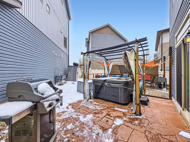 snow covered patio featuring a hot tub, a pergola, and a grill