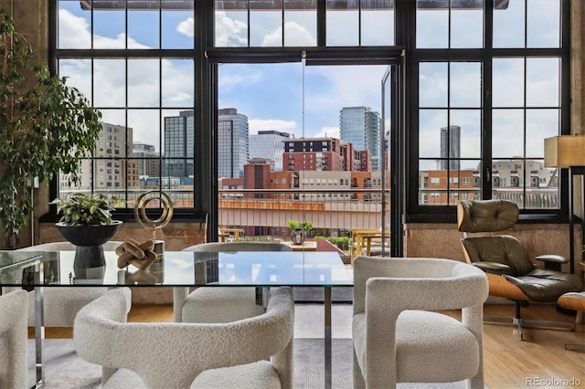dining space with a city view and wood finished floors