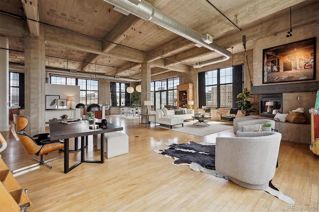 living area with wood ceiling, hardwood / wood-style flooring, and beamed ceiling