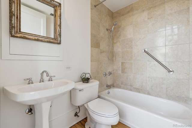bathroom with bathing tub / shower combination and toilet
