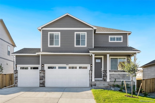 craftsman house featuring a garage, a porch, and a front yard