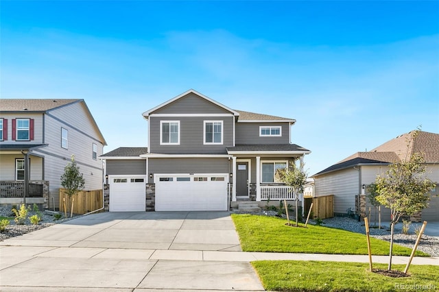 view of front of home featuring a porch, a garage, and a front yard