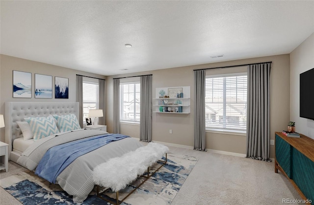 carpeted bedroom with a textured ceiling