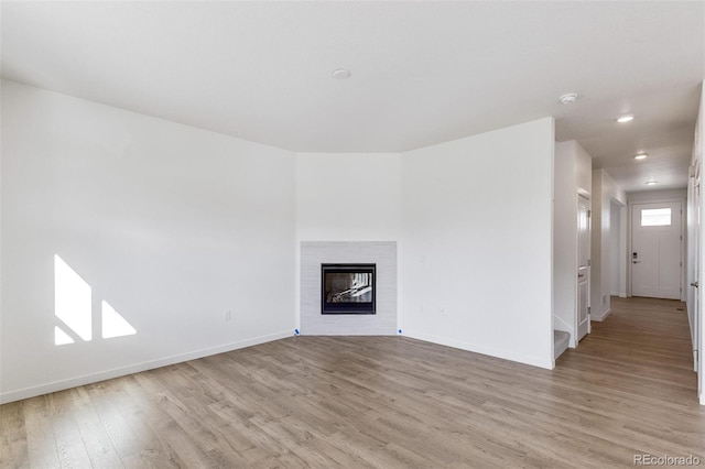 unfurnished living room with light hardwood / wood-style flooring