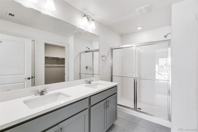 bathroom featuring walk in shower and vanity