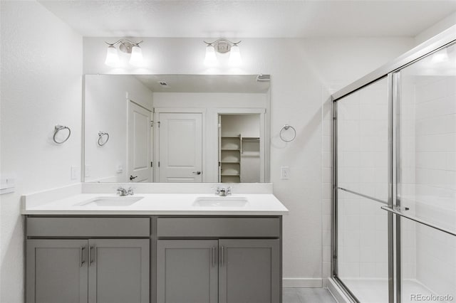 bathroom featuring vanity and a shower with door