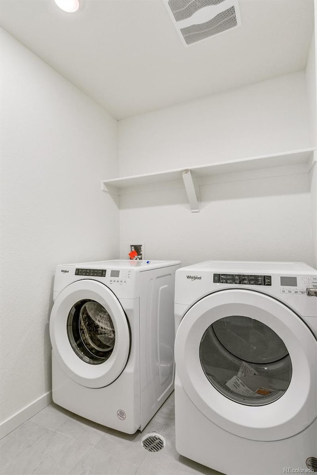 clothes washing area with washer and dryer