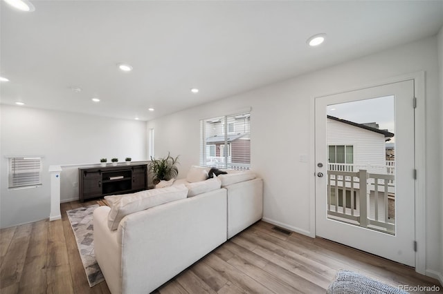 living room with light hardwood / wood-style flooring