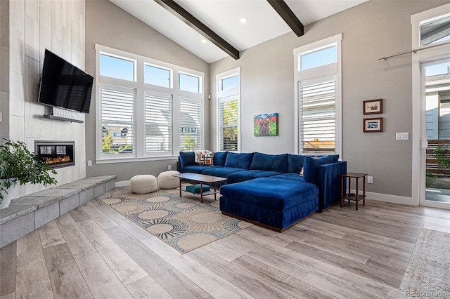 10179 E 59th N Pl, Denver, CO 80238 - living room featuring light wood-style floors, baseboards, beamed ceiling, a tiled fireplace, and high vaulted ceiling