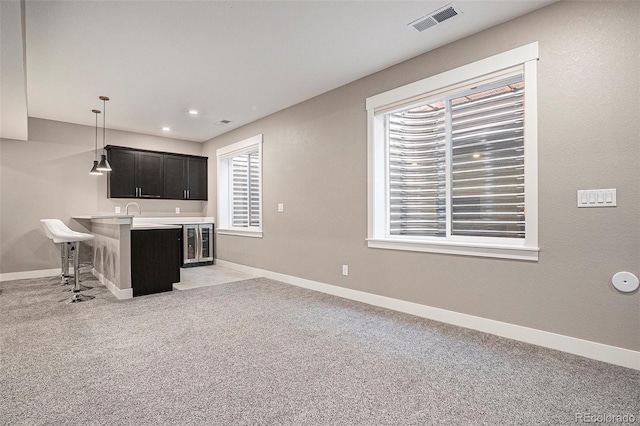 10179 E 59th N Pl, Denver, CO 80238 - indoor wet bar with light colored carpet, baseboards, decorative light fixtures, and recessed lighting