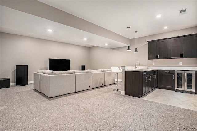 10179 E 59th N Pl, Denver, CO 80238 - kitchen featuring beverage cooler, open floor plan, light colored carpet, a kitchen bar, and recessed lighting