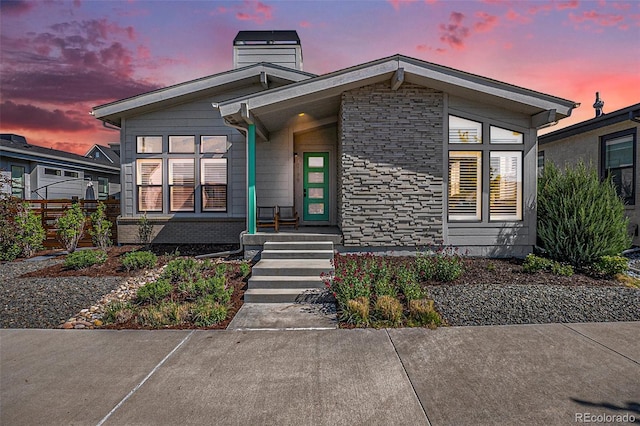 10179 E 59th N Pl, Denver, CO 80238 - mid-century modern home featuring a chimney, fence, and stone siding