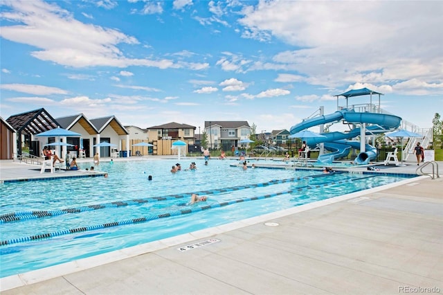 10179 E 59th N Pl, Denver, CO 80238 - community pool featuring a water slide, a patio area, and a residential view