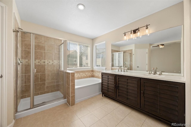 bathroom featuring tile patterned flooring, a garden tub, double vanity, a sink, and a stall shower