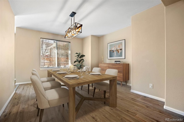 dining room featuring baseboards and wood finished floors