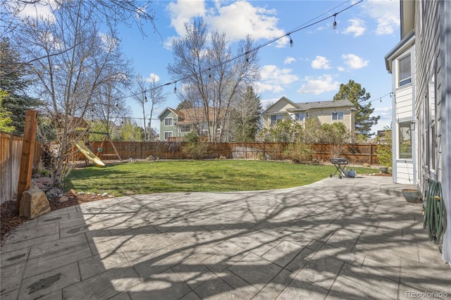 view of patio with a fenced backyard and a playground