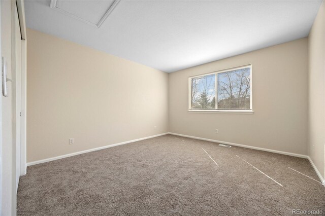 unfurnished room with carpet floors, baseboards, and visible vents