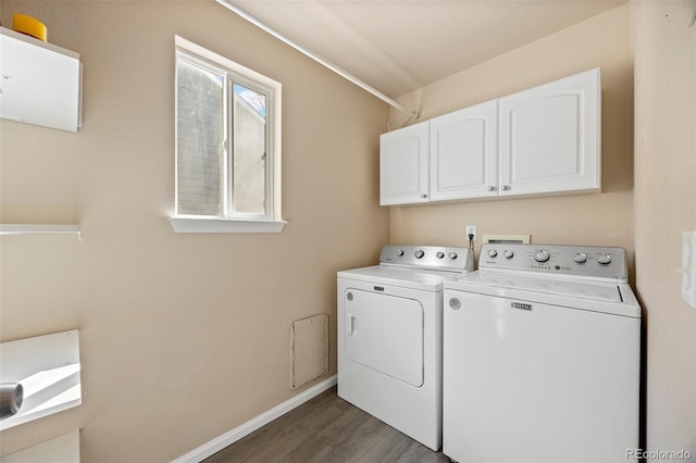 laundry room with separate washer and dryer, baseboards, cabinet space, and wood finished floors