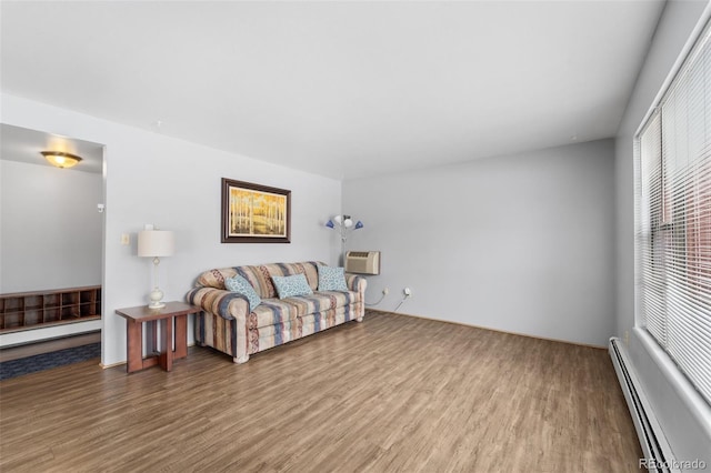 1625 W Elizabeth St Unit G2, Fort Collins, CO 80521 - living area featuring a baseboard heating unit, wood finished floors, and an AC wall unit