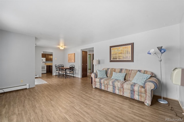 1625 W Elizabeth St Unit G2, Fort Collins, CO 80521 - living room featuring wood finished floors, baseboard heating, and a baseboard radiator