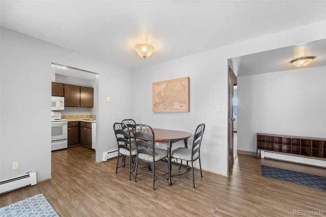 1625 W Elizabeth St Unit G2, Fort Collins, CO 80521 - dining space featuring a baseboard radiator and wood finished floors