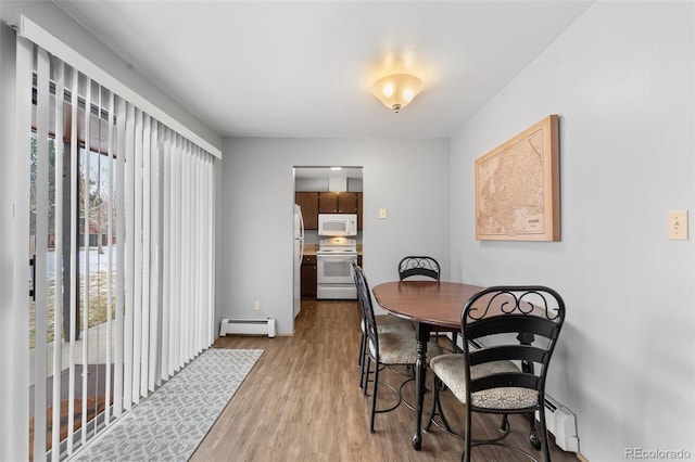 1625 W Elizabeth St Unit G2, Fort Collins, CO 80521 - dining space with a baseboard heating unit and wood finished floors