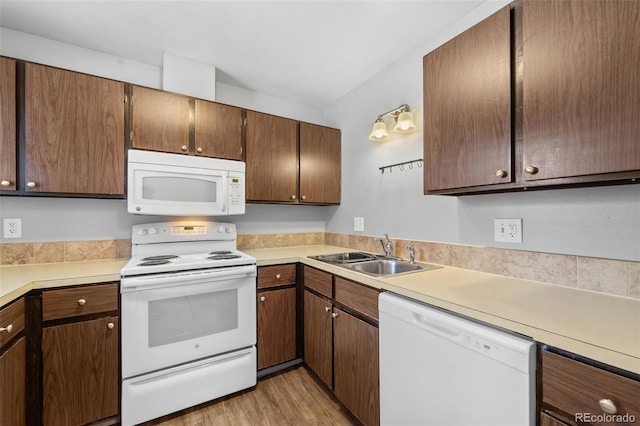 1625 W Elizabeth St Unit G2, Fort Collins, CO 80521 - kitchen featuring white appliances, light countertops, and light wood-type flooring
