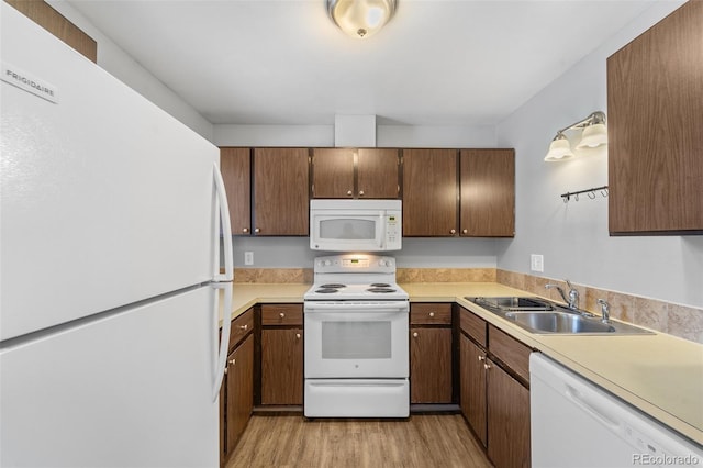 1625 W Elizabeth St Unit G2, Fort Collins, CO 80521 - kitchen with white appliances, light countertops, and light wood finished floors