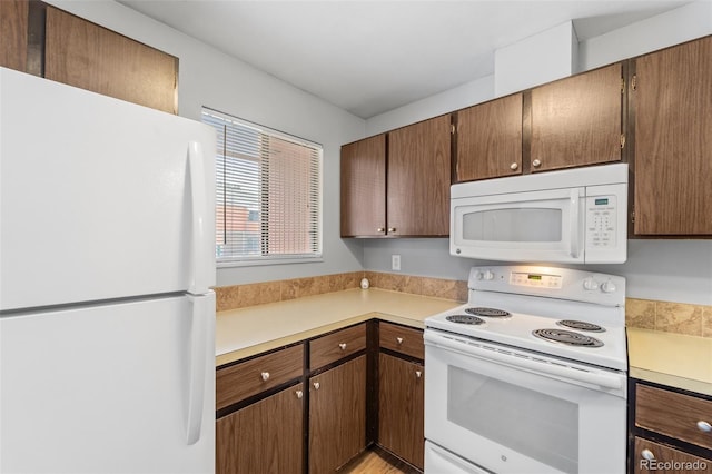 1625 W Elizabeth St Unit G2, Fort Collins, CO 80521 - kitchen with white appliances and light countertops