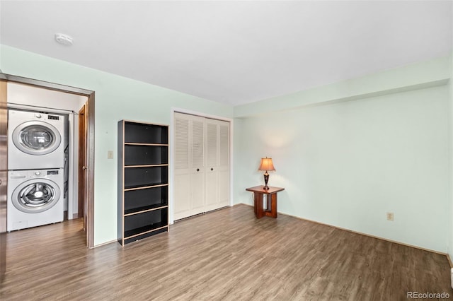 1625 W Elizabeth St Unit G2, Fort Collins, CO 80521 - washroom featuring estacked washer and dryer and wood finished floors