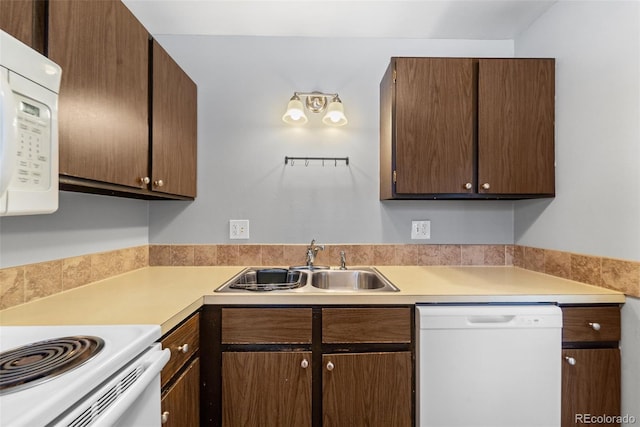 1625 W Elizabeth St Unit G2, Fort Collins, CO 80521 - kitchen with white appliances, light countertops, and dark brown cabinets